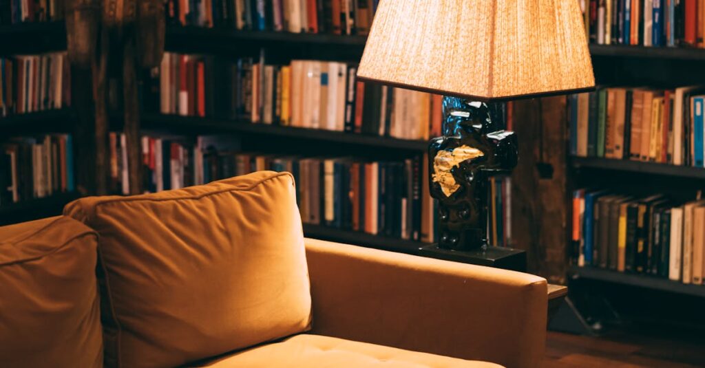 Warm and inviting library scene featuring a cozy couch, bookshelves, and a lamp for ambient lighting.